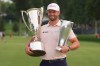 Wyndham Clark holds the Wanamaker Trophy and the BMW trohy after winning the BMW Championship golf tournament, Sunday, Aug. 23, 2026, in St. Louis. (AP Photo/Jeff Roberson)