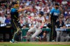 Atlanta Braves' Lane Thomas, center, scores past Philadelphia Phillies catcher J.T. Realmuto, left, and pitcher Cristopher Sánchez on a single by Austin Riley during the second inning of a baseball game Friday, Sept. 4, 2026, in Philadelphia. (AP Photo/Matt Slocum)