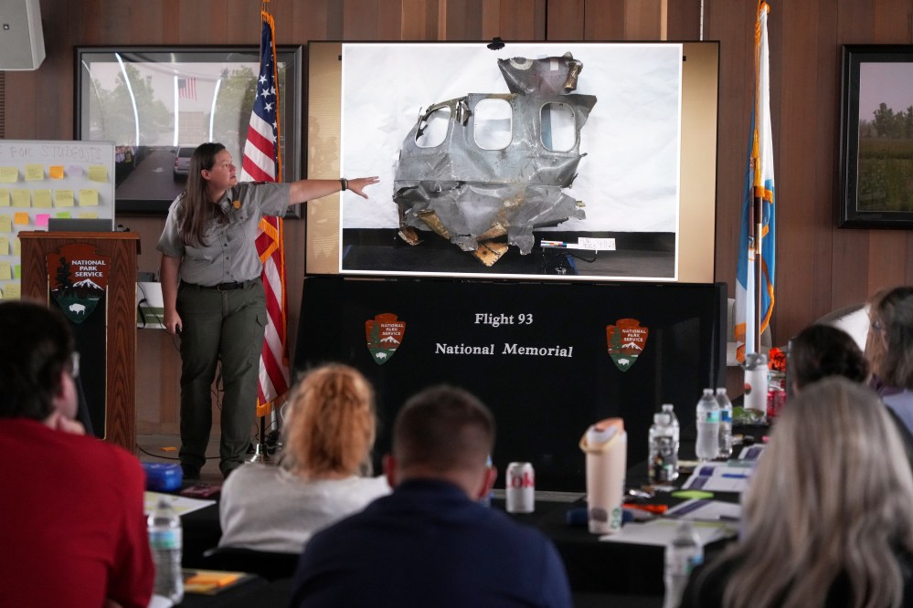 U.S. Park Ranger Betsy Keene, supervisor of Western Pennsylvania National Parks, explains a slide showing the damaged portion of United Flight 93 during a workshop for educators at the Flight 93 National Memorial in Shanksville, Pennsylvania, Tuesday, June 23, 2026. (AP Photo/Gene J. Puskar)