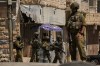 Members of the Israeli forces move on a street during a military raid in the West Bank town of Anata, Tuesday, Sept. 8, 2026. (AP Photo/Leo Correa)