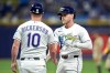 Tampa Bay Rays' Taylor Walls celebrates with first base coach Corey Dickerson (10) after his RBI single off San Diego Padres pitcher Casey Mize during the fourth inning of a baseball game Friday, Aug. 28, 2026, in St. Petersburg, Fla. (AP Photo/Chris O'Meara)