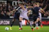 Newcastle United's Nico Gonzalez, left, and Millwall's Daniel Kelly battle for the ball during the English League Cup third round soccer match in London, Tuesday Sept. 8, 2026. (John Walton/PA via AP)
