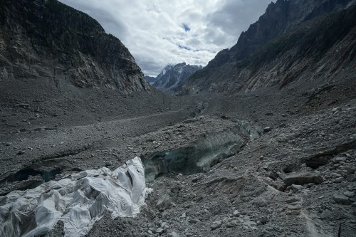 Tarpaulins cover the ice cave of the 'Mer de Glace' glacier to prevent it from melting, at the Montenvers station in Chamonix, France, Saturday, Sept. 5, 2026. (AP Photo/Laurent Cipriani)