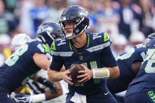 Seattle Seahawks quarterback Sam Darnold turns with the ball during the first half of an NFL football game against the New England Patriots, Wednesday, Sept. 9, 2026, in Seattle. (AP Photo/Lindsey Wasson)