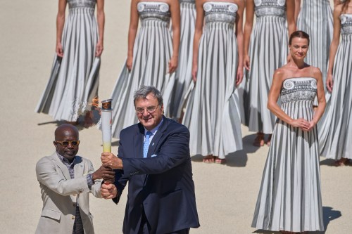 Dakar 2026 Organizing Committee president Mamadou Diagna Ndiaye, left, and Hellenic Olympic Committee president Isidoros Kouvelos, hold the Olympic torch during the Dakar 2026 Youth Olympic Games flame handover ceremony at the Panathenaic Stadium in Athens, Greece, Thursday, Sept. 10, 2026. (AP Photo/Petros Giannakouris)