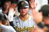 FILE - Pittsburgh Pirates' Ryan O'Hearn is congratulated in the dugout after scoring in the second inning of the second baseball game of a split doubleheader against the Cleveland Guardians in Cleveland, June 18, 2026. (AP Photo/Sue Ogrocki, File)