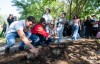 Attendees spread wildflower seeds in the Peace Garden as they take part in a ceremony commemorating the 20th anniversary of the shooting at Dawson College, where one student was killed and 19 others were wounded, in Montreal on Friday, Sept. 11, 2026. THE CANADIAN PRESS/Christinne Muschi