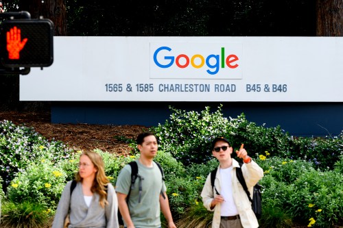 People wait to cross a road at Google headquarters on Thursday, March 26, 2026, in Mountain View, Calif. (AP Photo/Noah Berger)