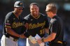 Pittsburgh Pirates' Esmerlyn Valdez, center, is helped off the field by first base coach Tarrik Brock, left, and a trainer during the sixth inning of a baseball game against the Chicago Cubs, Friday, Sept. 11, 2026, in Chicago. (AP Photo/Melissa Tamez)