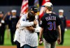 Derek Jeter hugs Brielle Saracini before she throws out the ceremonial first pitch with husband Sean McGuire before a baseball game between the New York Yankees and the New York Mets, Friday, Sept. 11, 2026, in New York. (AP Photo/Noah K. Murray)
