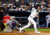 New York Yankees' Cody Bellinger follows through on a three run home run against the New York Mets during the second inning of a baseball game, Friday, Sept. 11, 2026, in New York. (AP Photo/Noah K. Murray)