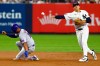New York Mets' Marcus Semien is out at second as New York Yankees shortstop George Lombard Jr. makes a throw to first base during the seventh inning of a baseball game, Friday, Sept. 11, 2026, in New York. (AP Photo/Noah K. Murray)
