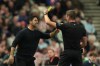 Referee John Brooks, right, shows a yellow card to Arsenal's manager Mikel Arteta during the English Premier League soccer match between Sunderland and Arsenal in Sunderland, England, Saturday, Sept. 12, 2026. (AP Photo/Ian Hodgson)