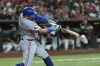 Texas Rangers' Jake Burger connects for a single against the Arizona Diamondbacks during the fifth inning of a baseball game, Saturday, Sept. 12, 2026, in Phoenix. (AP Photo/Ross D. Franklin)