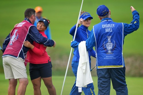 Charley Hull of Europe, second right, reacts after beating Megan Khang of the United States, second left, after winning their singles match during the final day of the Solheim Cup in Den Bosch, Netherlands, Sunday, Sept. 13, 2026. (AP Photo/Alastair Grant)