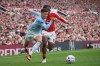 Manchester City's Phil Foden, left, challenges for the ball with Manchester United's Patrick Dorgu during the English Premier League soccer match between Manchester United and Manchester City in Manchester, England, Sunday, Sept. 13, 2026. (AP Photo/Ian Hodgson)