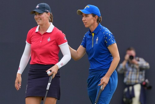 Carlota Ciganda of Europe, right, greets Jennifer Kupcho of the United States on the 16th green after winning their singles match during the final day of the Solheim Cup in Den Bosch, Netherlands, Sunday, Sept. 13, 2026. (AP Photo/Alastair Grant)