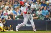 Cincinnati Reds' Eugenio Suárez hits a three-run home run during the sixth inning of a baseball game against the Milwaukee Brewers, Sunday, Sept. 13, 2026, in Milwaukee. (AP Photo/Kayla Wolf)