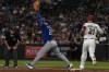 Texas Rangers' first baseman Jake Burger (21) catches a throw from shortstop Corey Seager (5) to get the out on Arizona Diamondbacks' Lars Nootbaar during the third inning of a baseball game, Sunday, Sept. 13, 2026, in Phoenix. (AP Photo/Caitlin O'Hara)