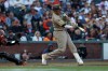 San Diego Padres' Manny Machado, right, hits a two-run home run in front of San Francisco Giants catcher Andrew Knizner, left, during the second inning of a baseball game in San Francisco, Sunday, Sept. 13, 2026. (AP Photo/Jed Jacobsohn)