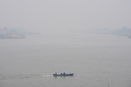A boat cruises on Kapuas River amid the thick haze from forest fires, in Pontianak, West Kalimantan, Indonesia, Monday, Sept. 14, 2026. (AP Photo/Tatan Syuflana)