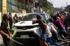A group attacks a vehicle from an opposing group outside a school used as a polling center during the Bangsamoro Autonomous Region in Muslim Mindanao parliamentary elections in Cotabato city, southern Philippines, Monday, Sept. 14, 2026. (AP Photo)