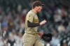 San Diego Padres relief pitcher Mason Miller reacts after third baseman Manny Machado fielded a ground ball and put out Colorado Rockies' Adael Amador to end the ninth inning of a baseball game Monday, Sept. 14, 2026, in Denver. (AP Photo/David Zalubowski)