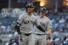 New York Yankees left fielder Cody Bellinger, front, jogs toward the dugout after crossing home plate after hitting a 2-run home run during the first inning of a baseball game against the Minnesota Twins Tuesday, Sept. 15, 2026, in Minneapolis. (AP Photo/Abbie Parr)