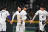From left, Colorado Rockies second baseman Adael Amador congratulates center fielder Cole Carrigg as shortstop Ezequiel Tovar commends right fielder Zac Veen after defeating the San Diego Padres in a baseball game Tuesday, Sept. 15, 2026, in Denver. (AP Photo/David Zalubowski)