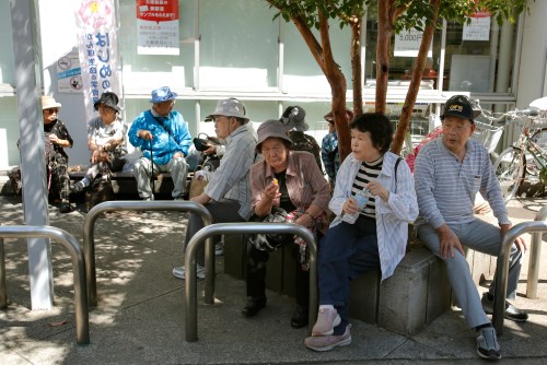 Elderly people rest under the shade of a tree in Tokyo, Sunday, Sept. 14, 2014. (AP Photo/Shizuo Kambayashi, File)