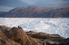 FILE - NYU student researchers sit on top of a rock overlooking the Helheim glacier in Greenland, Aug. 16, 2019. (AP Photo/Felipe Dana, File)