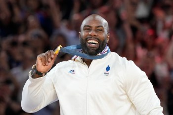 FILE - Golden medalist France's Teddy Riner poses on the podium of the judo men's +100 kg event in the team judo competition, at Champ-de-Mars Arena, during the 2024 Summer Olympics, Friday, Aug. 2, 2024, in Paris, France. (AP Photo/Eugene Hoshiko, File)