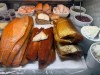 Various smoked fish are displayed behind the counter at Tal Bagels in New York on Sept. 13, 2026. (Katie Workman via AP)