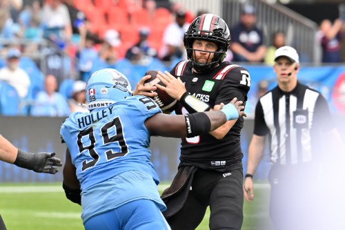 Ottawa Redblacks quarterback McLeod Bethel-Thompson (3) is sacked by Toronto Argos defensive tackle Ralph Holley (99) during second half CFL football action in Toronto on Saturday, Sept. 12, 2026. THE CANADIAN PRESS/Jon Blacker