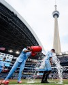 Toronto Blue Jays' Vladimir Guerrero Jr., centre, douses Myles Straw, right, with sports drink after defeating the Detroit Tigers 5-1 during MLB action in Toronto, on Wednesday, Sept. 16, 2026. THE CANADIAN PRESS/Keito Newman