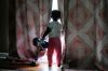 Khalidou Sy's young daughter looks out a window inside the family's home in Lockland, Ohio, Friday, July 31, 2026. (AP Photo/Carolyn Kaster)