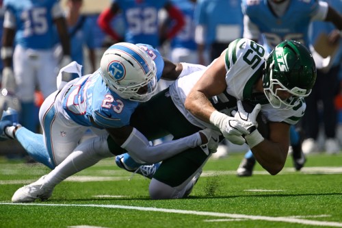 New York Jets tight end Mason Taylor (85) is tackled by Tennessee Titans safety Kevin Winston Jr. (23) during the first half of an NFL football game Sunday, Sept. 13, 2026, in Nashville, Tenn. (AP Photo/John Amis)