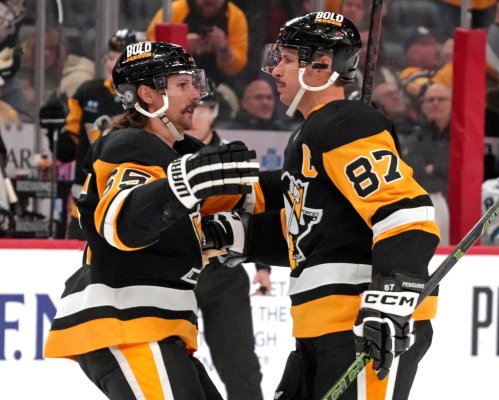 FILE - Pittsburgh Penguins' Sidney Crosby (87) celebrates scoring a goal with Erik Karlsson during the second period of an NHL hockey game against the San Jose Sharks, Nov. 16, 2024, in Pittsburgh. (AP Photo/Gene J. Puskar, File)