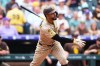 San Diego Padres' Xander Bogaerts hits a triple in the second inning of a baseball game against the Colorado Rockies, Thursday, Sept. 17, 2026, in Denver. (AP Photo/David Zalubowski)