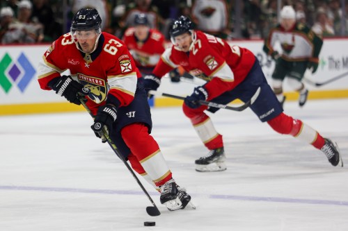 FILE - Florida Panthers' Brad Marchand (63) controls the puck against the Minnesota Wild during the second period of an NHL hockey game Jan. 24, 2026, in St. Paul, Minn. (AP Photo/Lily Dozier, File)