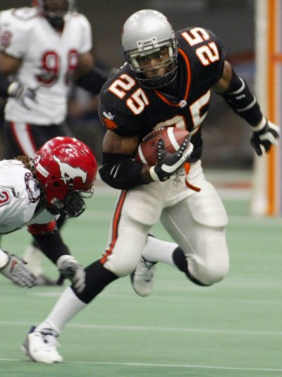 B.C. Lions Sean Millington (right) tries to break free from Calgary Stampeders Kelly Malveaux during the second quarter of CFL action in Vancouver, B.C. on Friday, October 11, 2002. (CP PHOTO/Richard Lam)