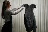 A dress worn by the late Princess Diana and known as the ''Revenge Dress'', designed by Christina Stambolian, is unveiled by staff at Sotheby’s auction house in London, Friday, Sept. 18, 2026, ahead of its Dec. 9 auction in New York, where it is estimated to sell for US$150,000-300,000. (AP Photo/Alastair Grant)