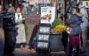 FILE - A woman shares Jehovah's Witnesses' literature with a passerby in downtown Pittsburgh on Nov. 13, 2023. (AP Photo/Peter Smith, File)