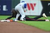 Cincinnati Reds' Elly De La Cruz, bottom, steals second base before Chicago Cubs second baseman Nico Hoerner, top, can apply a tag during the first inning of a baseball game Friday, Sept. 18, 2026, in Cincinnati. (AP Photo/Kareem Elgazzar)