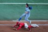 Texas Rangers first baseman Jake Burger, bottom, puts out Toronto Blue Jays' Brett Bateman on a groundout during the third inning of a baseball game Friday, Sept. 18, 2026, in Arlington, Texas. (AP Photo/Julio Cortez)