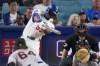 Los Angeles Dodgers' Josue de Paula, second from left, hits an RBI double as San Francisco Giants pitcher Jason Foley, left, and catcher Drew Cavanaugh watch during the sixth inning of a baseball game Friday, Sept. 18, 2026, in Los Angeles. (AP Photo/Mark J. Terrill)