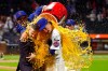 New York Mets' Carson Benge, right, hugs announcer Steve Gelbs, left, as he gets doused with Gatorade after breaking the Mets rookie season record for hits in New York, Saturday, Sept. 19, 2026. (AP Photo/Noah K. Murray)