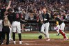 Arizona Diamondbacks' Pavin Smith celebrates with the team as he arrives home after scoring the game-winning home run during the ninth inning of a baseball game against the New York Yankees, Saturday, Sept. 19, 2026, in Phoenix. (AP Photo/Caitlin O'Hara)