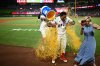 Los Angeles Angels' Christian Moore, center, is showered with an ice bucket after hitting a walk-off single during the 11th inning of a baseball game against the Minnesota Twins, Saturday, Sept. 19, 2026, in Anaheim, Calif. (AP Photo/William Liang)