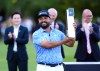 J. J. Spaun of United States lifts the trophy after winning the PGA Championship at Wentworth Golf Club in Virginia Water, England, Sunday Sept. 20, 2026. (Adam Davy/PA via AP)